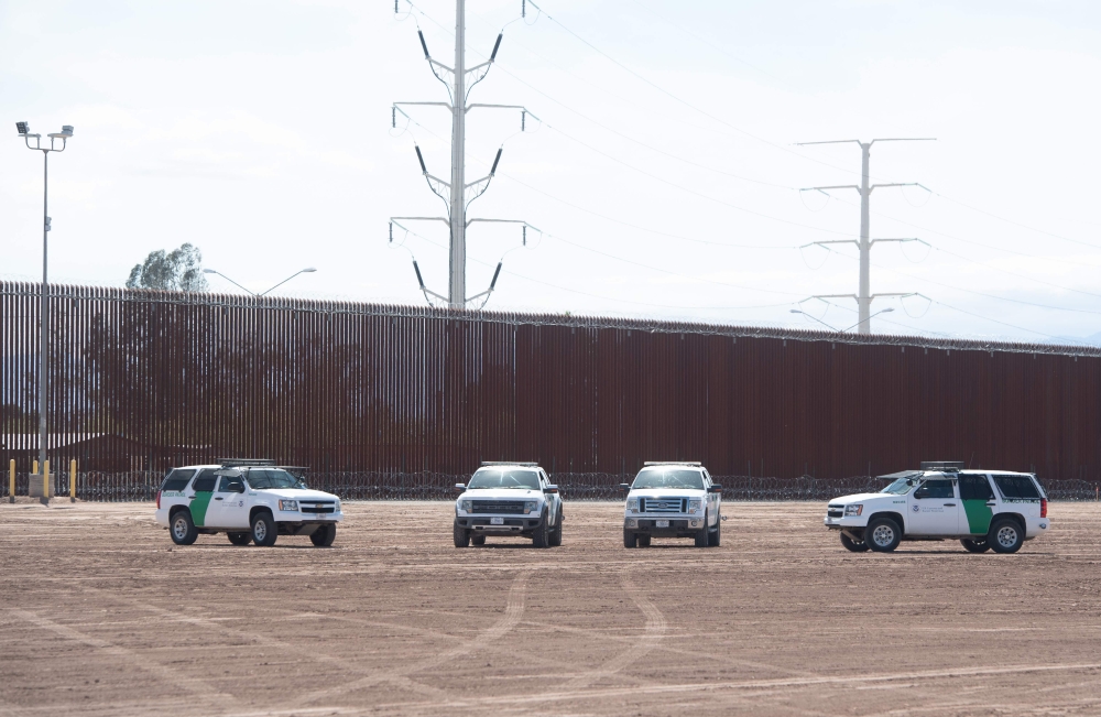 In this file photo taken on April 5, 2019 US Customs and Border Patrol cars are seen near the border wall between the United States and Mexico in Calexico, California. (AFP / SAUL LOEB)