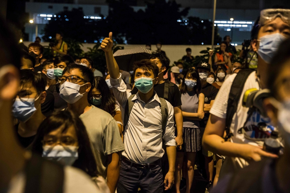 Protesters gather outside Kwai Chung police station in support of protesters detained with the charge of rioting during recent clashes in Hong Kong on July 30, 2019. (AFP / ISAAC LAWRENCE)