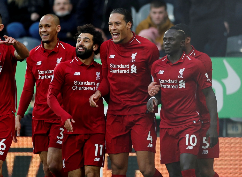 FILE PHOTO: Liverpool's Virgil van Dijk celebrates scoring their first goal with Mohamed Salah, Sadio Mane and teammates Action Images via Reuters/Lee Smith 