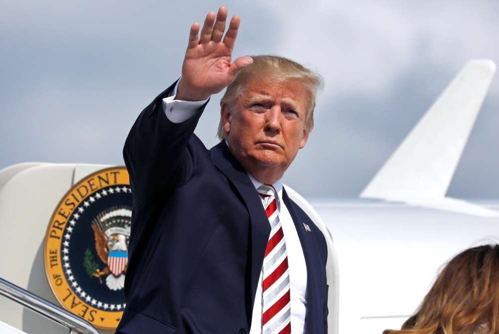 U.S. President Donald Trump waves as he boards Air Force One at Morristown municipal airport en route to Washington after a weekend in Bedminster, New Jersey, U.S., August 4, 2019. REUTERS/Yuri Gripas