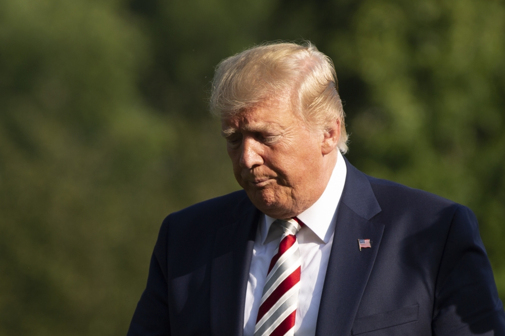 US President Donald Trump and First Lady Melania Trump (not pictured) return to the White House in Washington, DC, on August 4, 2019.  / AFP / Alastair Pike
