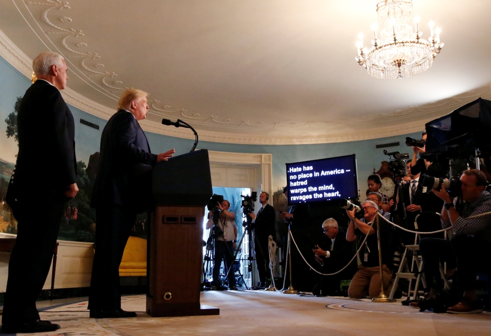 U.S. President Donald Trump speaks about the shootings in El Paso and Dayton as Vice President Mike Pence looks on in the Diplomatic Room of the White House in Washington, U.S., August 5, 2019. REUTERS/Leah Millis