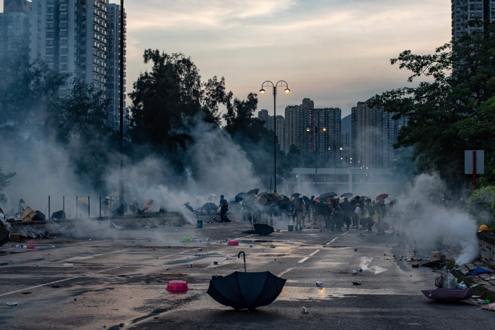 Protesters react after police fired tear gas in Tai Po district during a general strike in Hong Kong on August 5, 2019, as simultaneous rallies were held across seven districts.  AFP / Philip FONG