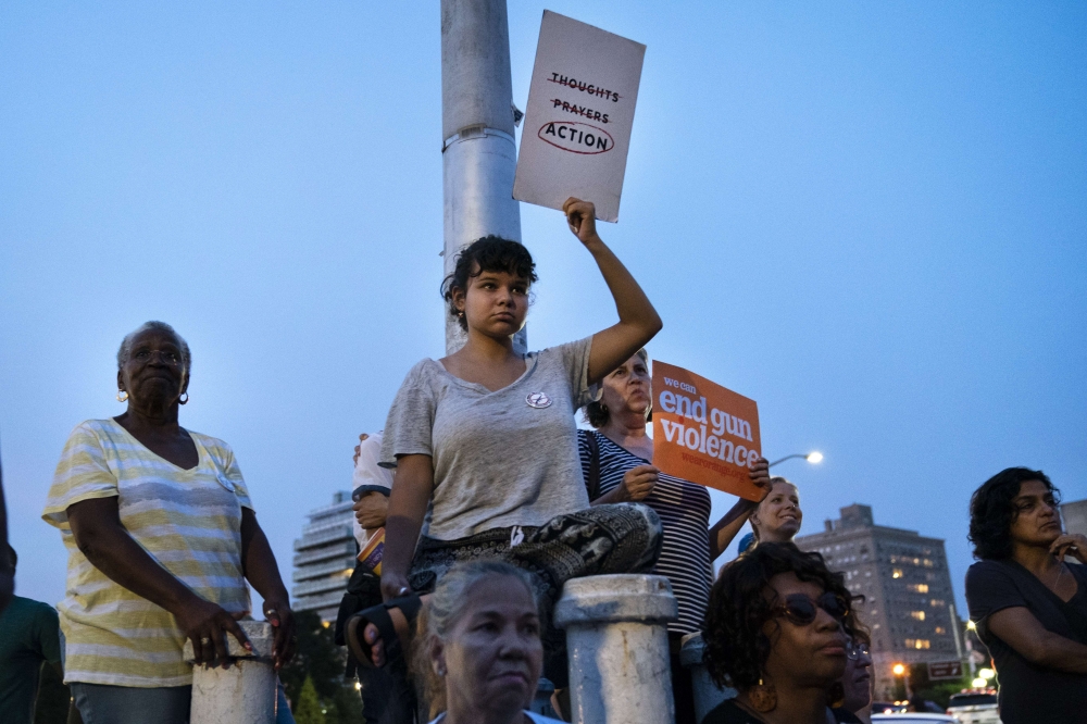 People attend a vigil for the victims of the recent mass shootings in El Paso, Texas and Dayton, Ohio, in Grand Army Plaza on August 5, 2019 in the Brooklyn borough of New York City. Drew Angerer/AFP