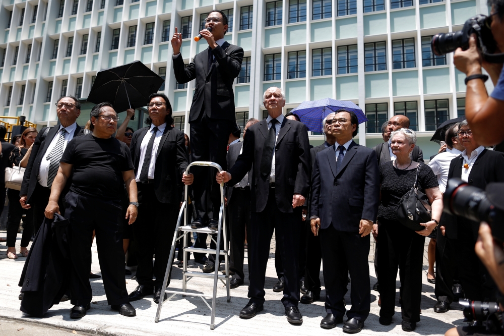 Lawyers and workers in Hong Kong's legal sector gather outside the Department of Justice during a protest in Hong Kong, China August 7, 2019. REUTERS/Thomas Peter