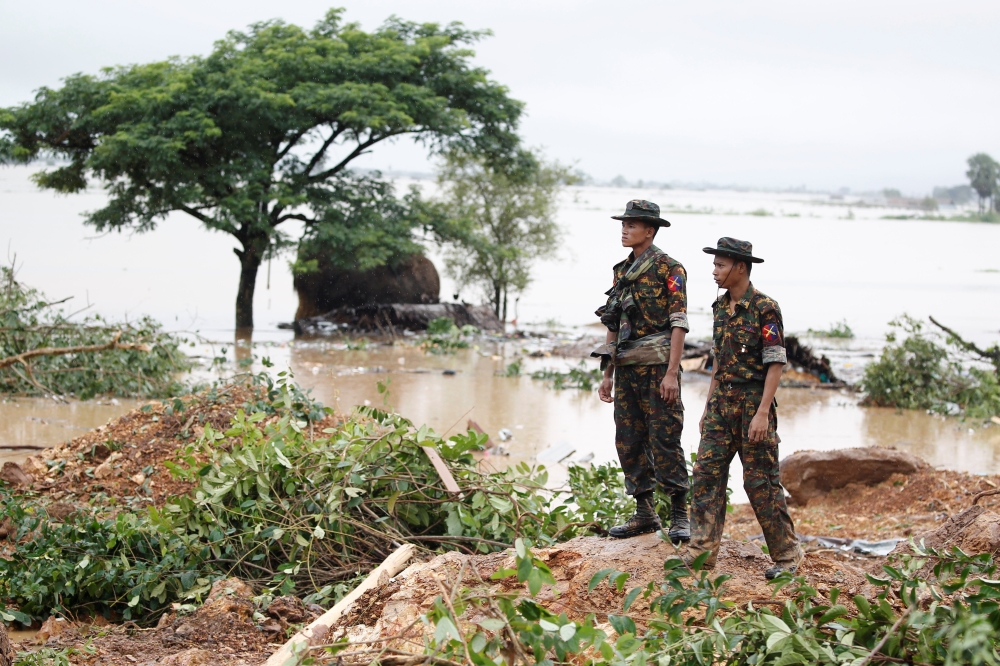 Rescue workers search for bodies under the debris and mud after a landslide in Mottama, Mon state, Myanmar, August 10, 2019. REUTERS/Ann Wang