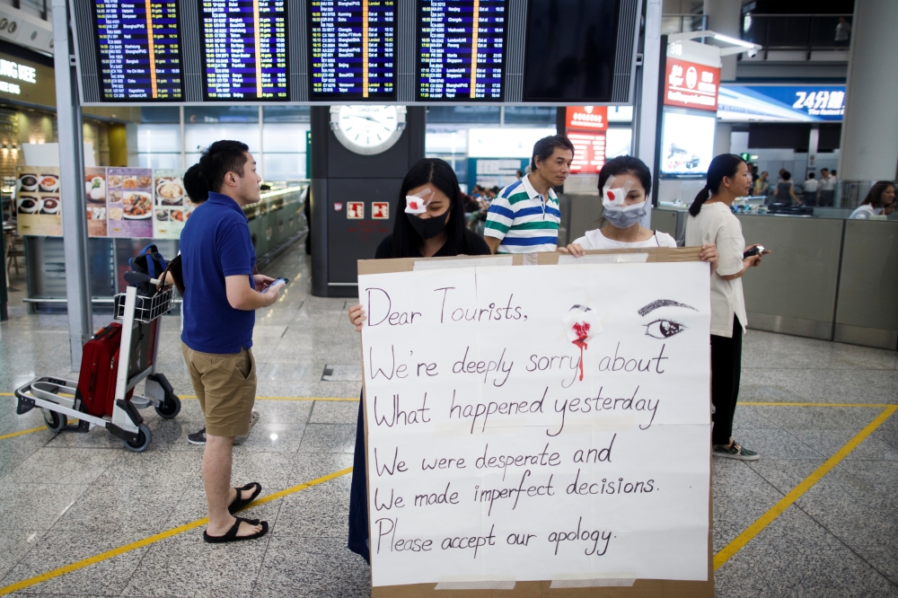 Anti-government demonstrators apologize for yesterday's clashes with police at the airport in Hong Kong China August 14, 2019. (REUTERS/Thomas Peter)