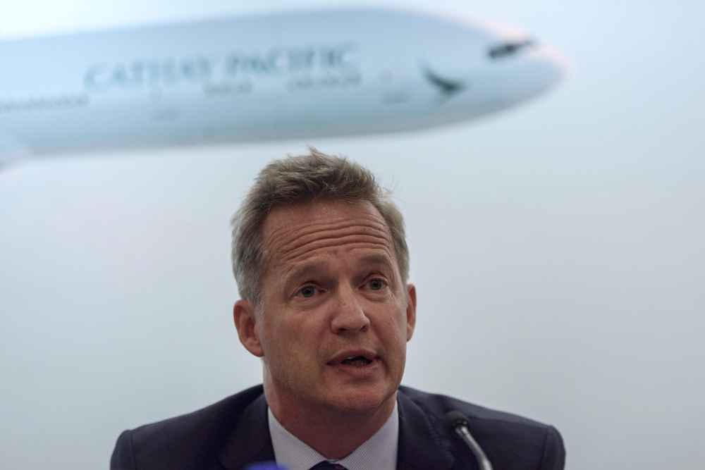This file photo taken on August 16, 2017 shows Cathay Pacific's chief executive officer Rupert Hogg speaking during a press conference on the company's half-year results in Hong Kong. / AFP / Anthony WALLACE 