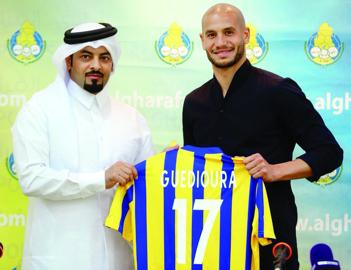 Al Gharafa’s new signing, Algerian star Adlene Guedioura (right) holding a team jersey with a club official during a press conference yesterday.