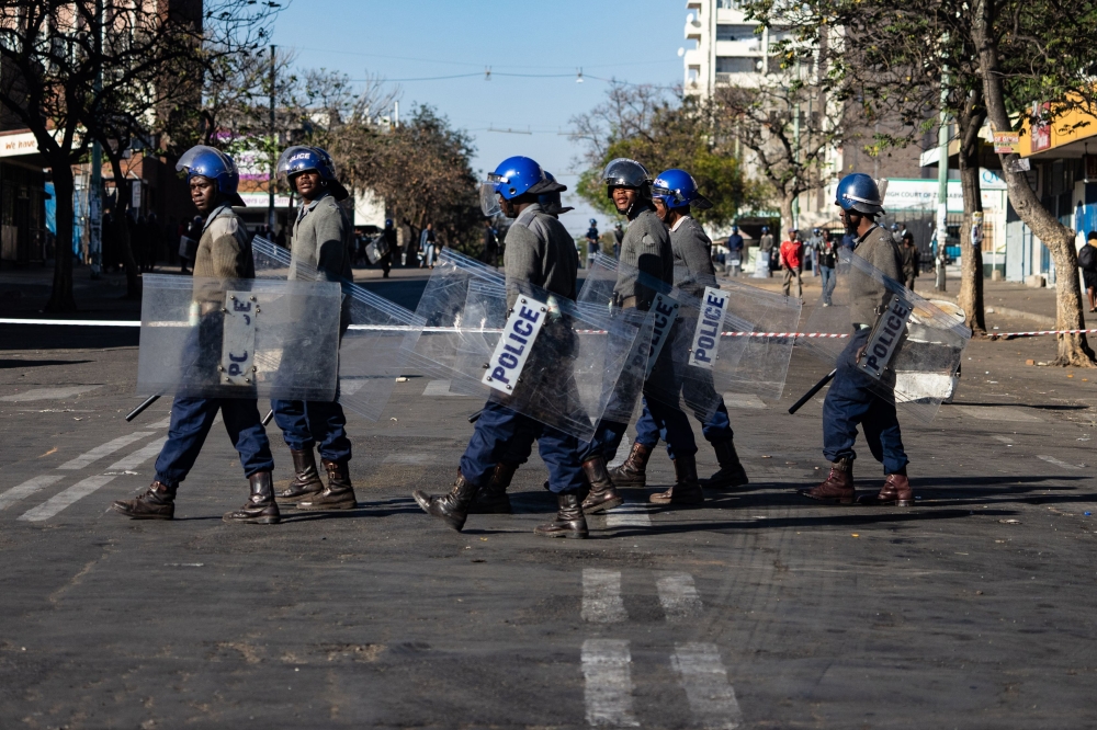 Police officers patrol near Tredgold Magistrates courts on August 19, 2019, in Bulawayo, Zimbabwe. AFP / Zinyange Auntony