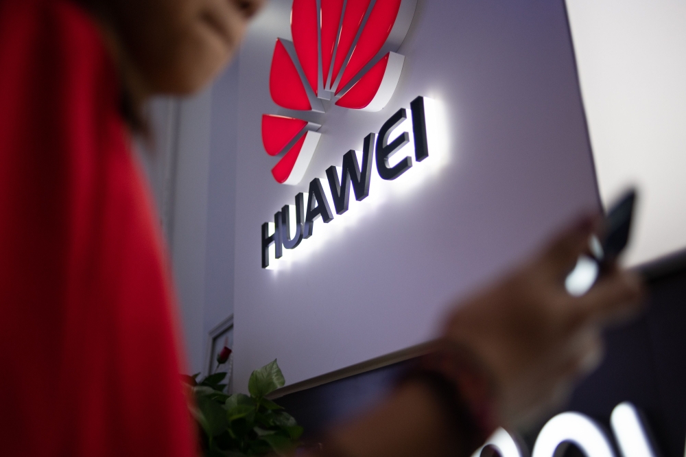 FILE PHOTO: Huawei logo is displayed at a retail store in Beijing.  AFP / FRED DUFOUR