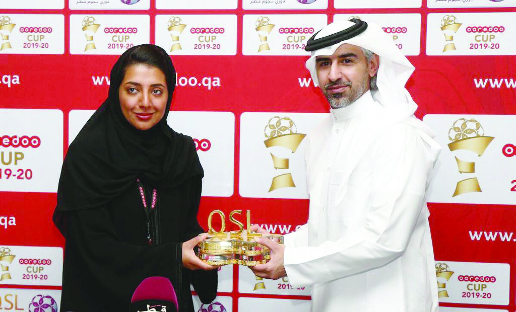 Moza Khalid Al Muhannadi (left), Director of Sponsorship, CSR & Media Strategy at Ooredoo, with Hassan Rabiah Al Kuwari, Executive Director of Marketing, Sales and Communication at Qatar Stars League (QSL) during the sponsorship signing in Doha, yesterday