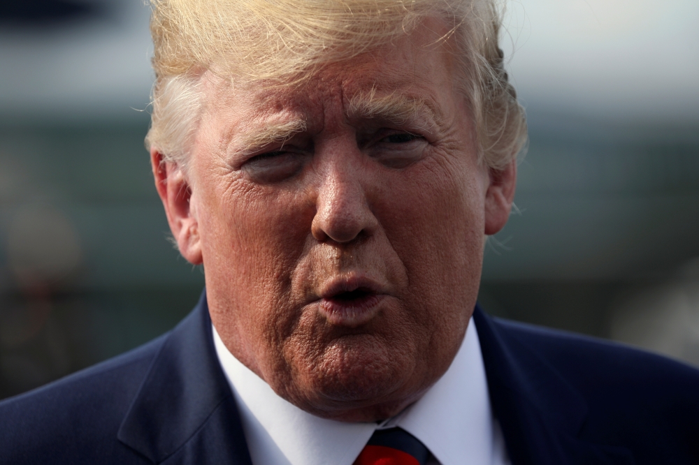 FILE PHOTO: US President Donald Trump speaks to reporters before boarding Air Force One to return to Washington from Morristown Municipal Airport in Morristown, New Jersey U.S. August 18, 2019. REUTERS/Jonathan Ernst/File Photo