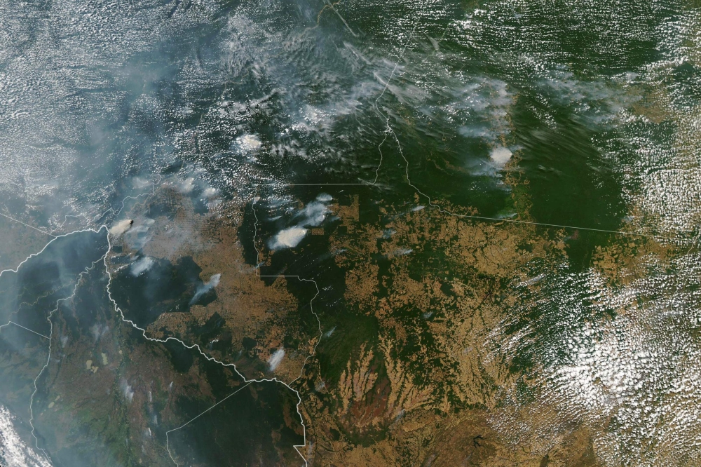This handout NASA Earth Observatory image obtained on August 21, 2019, captured by Moderate Resolution Imaging Spectroradiometer (MODIS) on NASA's Aqua satellite shows several fires burning in the Brazilian states of Amazonas (top C-L), Para (top R), Mato