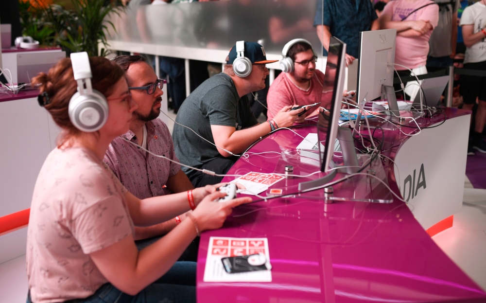 Visitors play the cloud-gaming based 