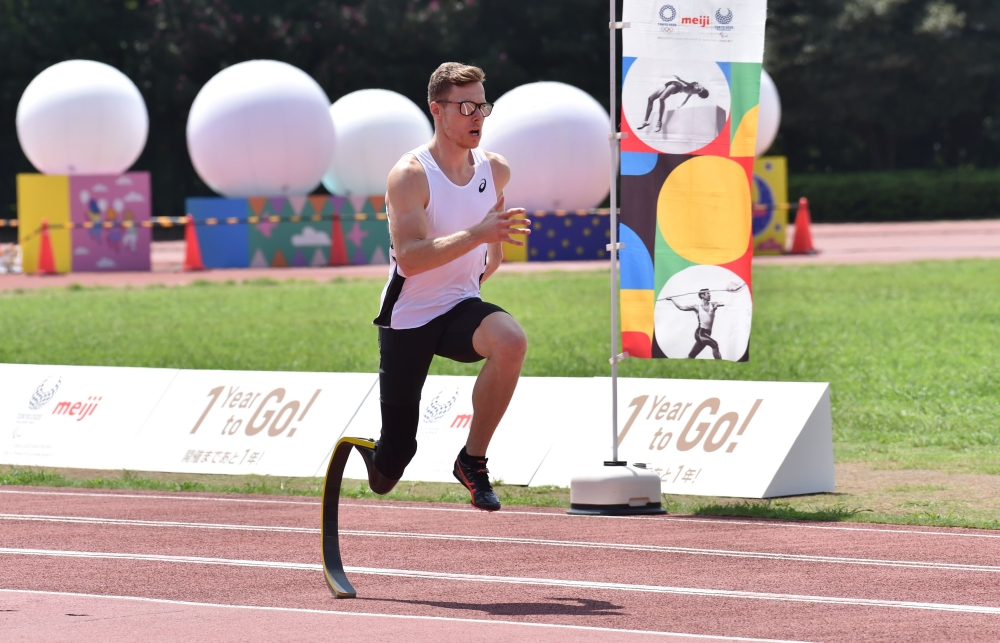 Germany's Paralympic athlete Markus Rehm warms up in a long jump demonstration in Tokyo on August 25, 2019, as part of a countdown event marking one year before the start of the Tokyo 2020 Paralympic Games. AFP / Kazuhiro NOGI