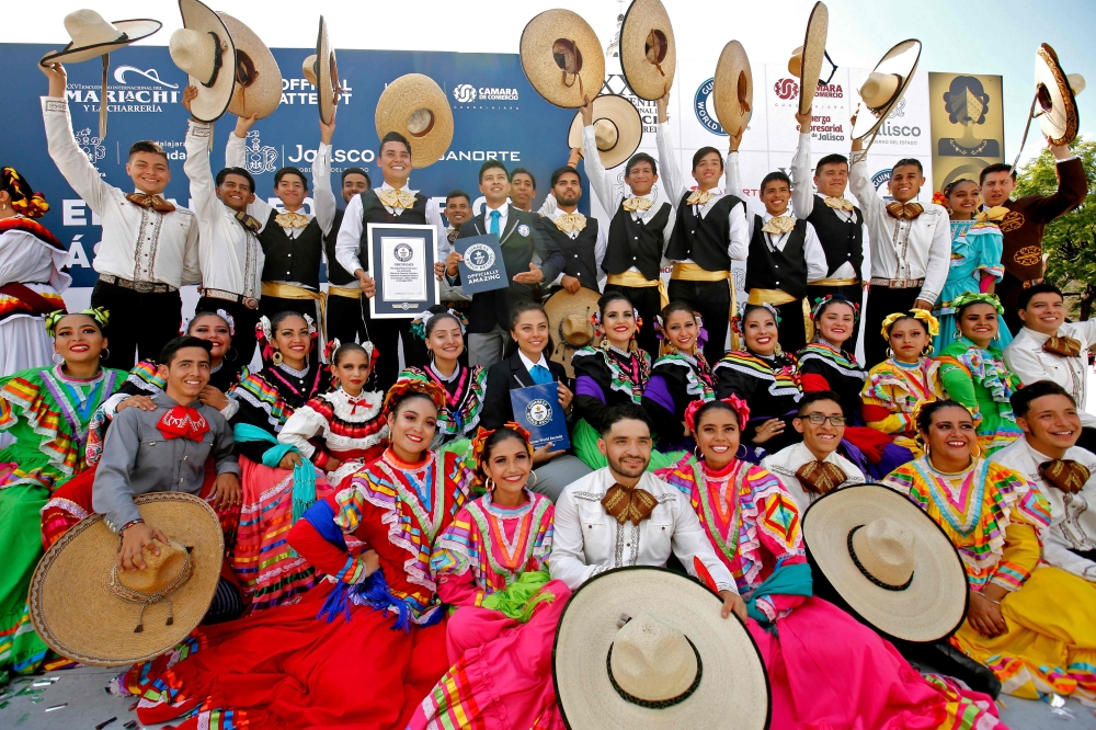 Mariachi dancers pose with the Guinness World Record of largest Mexican folk dance in Guadalajara, Jalisco state, Mexico, on August 24, 2019. AFP / Ulises Ruiz