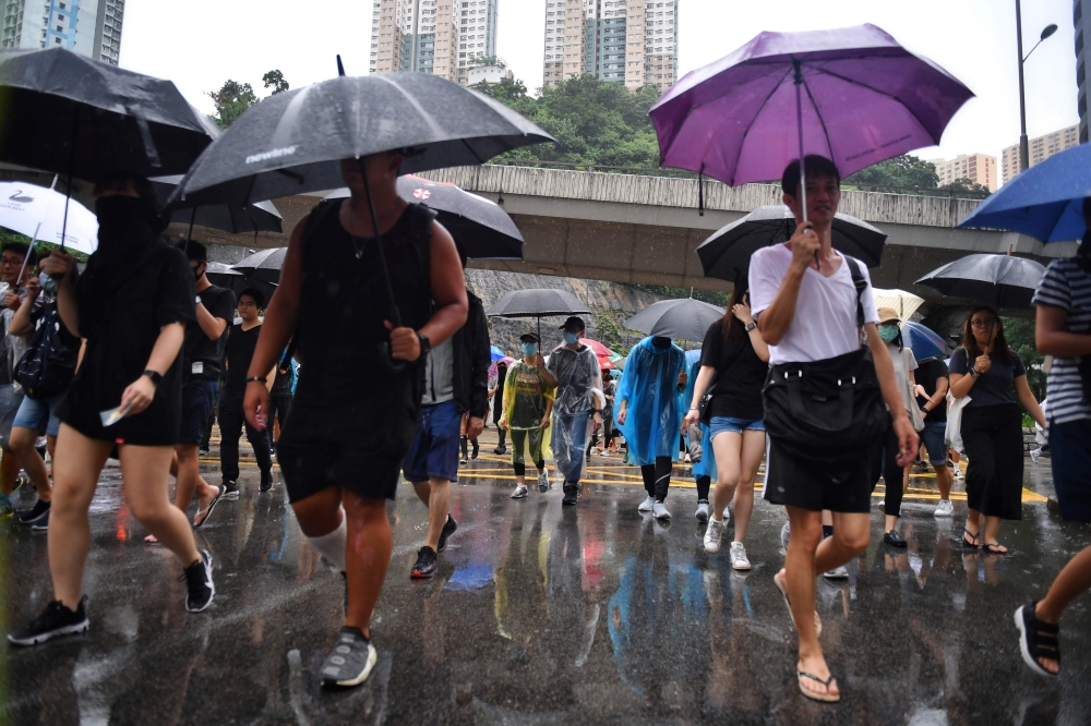 Protesters march together in Tseun Wan in Hong Kong on August 25, 2019, in the latest opposition to a planned extradition law that has since morphed into a wider call for democratic rights in the semi-autonomous city. AFP / Lillian Suwanrumpha 