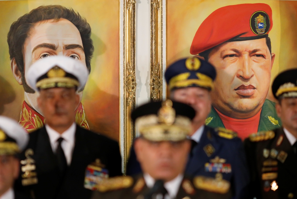 Portraits of Simon Bolivar and Hugo Chavez are seen during a news conference of Minister Vladimir Padrino Lopez in Caracas, Venezuela. January 24, 2019. Reuters/Manaure Quintero