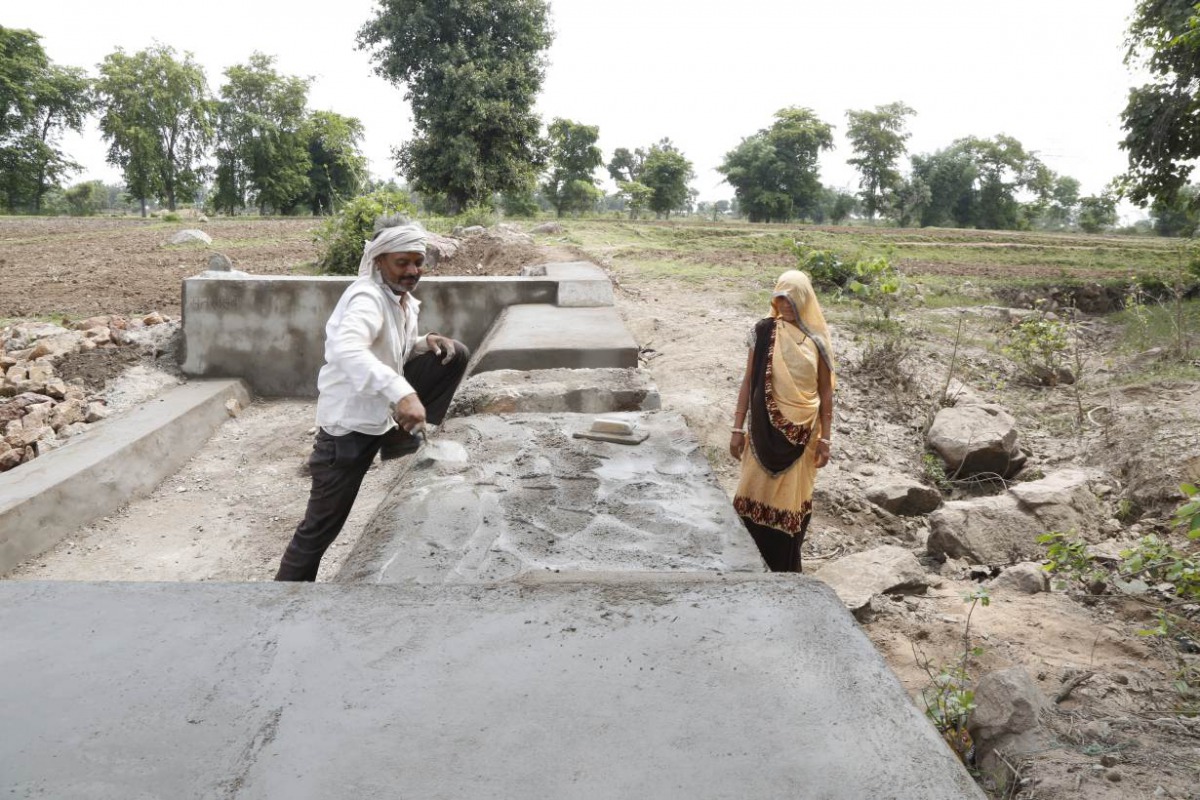 Kiran Aherwal, a Jal Saheli, or a woman water friend, supervises the making of a water outlet in Agroutha village of Bundelkhand, India on July 16, 2019. Thomson Reuters Foundation/Annie Banerji