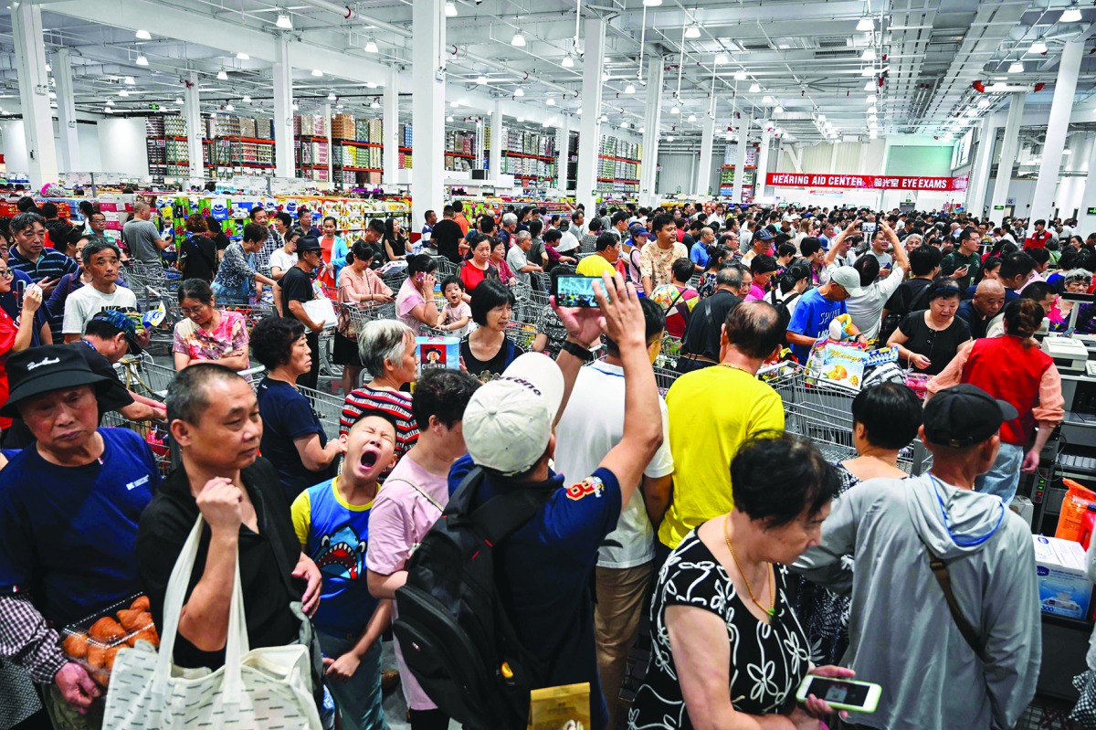 People visit the first Costco outlet in China, on the stores opening day in Shanghai on August 27, 2019.  AFP / Hector Retamal