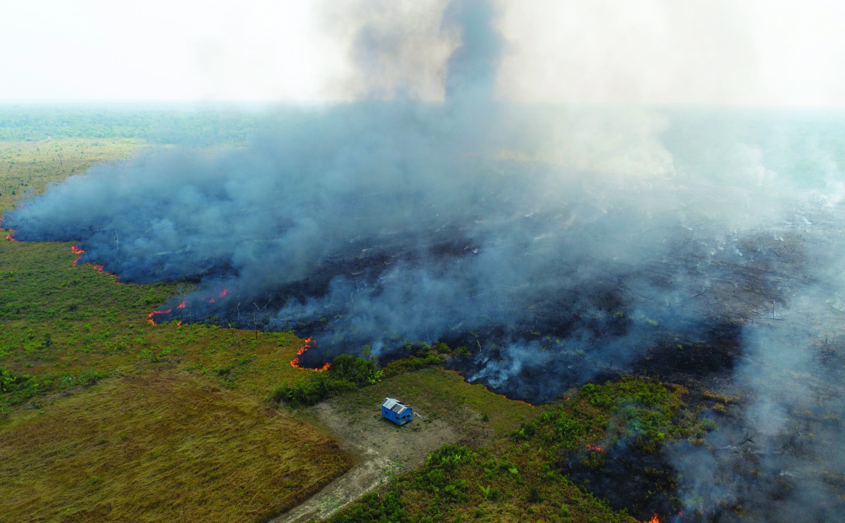 An aerial view shows smoke rising over a deforested plot of the Amazon jungle in Porto Velho, Rondonia State, Brazil, August 27. Picture taken with a drone. Reuters/Ueslei Marcelino