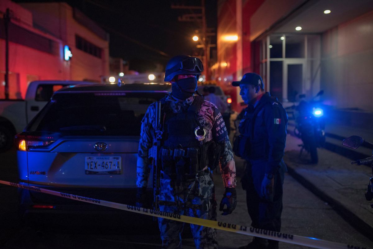 Federal forces keep watch at a crime scene following a deadly attack at a bar by unknown assailants in Coatzacoalcos, Mexico Aug. 28, 2019. Angel Hernandez / Reuters
