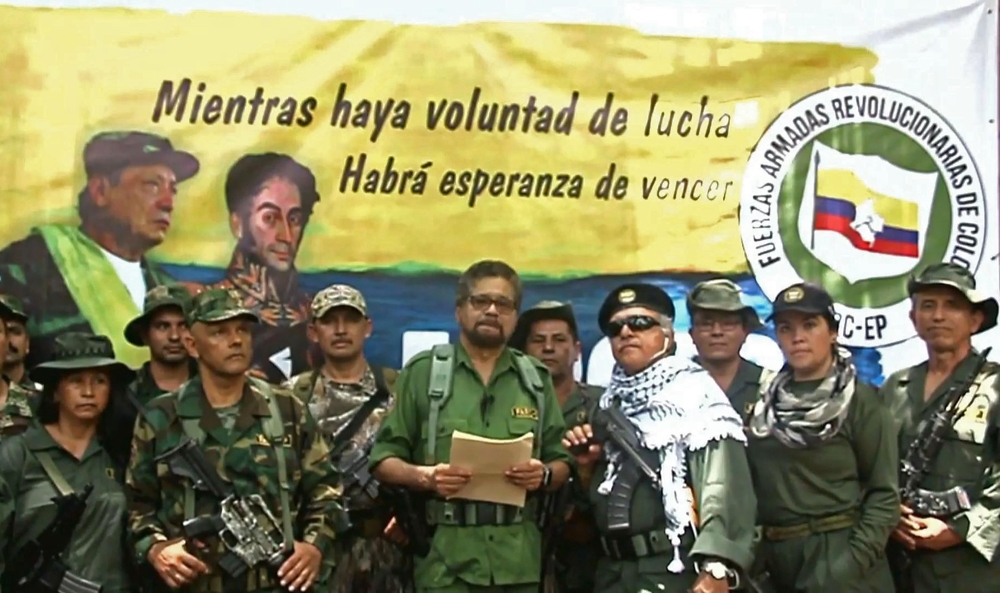 This TV grab taken from youtube and released on August 29, 2019 shows former senior commander Ivan Marquez(C) and fugitive rebel colleague, Jesus Santrich(wearing sunglass), of the dissolved FARC rebel army group in Colombia, on an undisclosed location of
