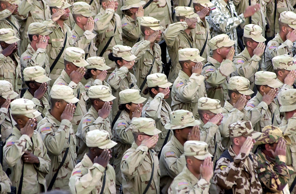 In this file photo taken on September 11, 2002, US soldiers salute during a flag lowering ceremony at the Bagram Air Base. AFP / Desha-Kalyan Chowdhury 