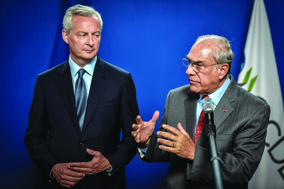 French Finance and Economy Minister Bruno Le Maire (L) flanked by the Organisation for Economic Co-operation and Development (OECD) Secretary General Jose Angel Gurria give a joint press conference at the Ministry of economy in Paris, on August 29, 2019. 