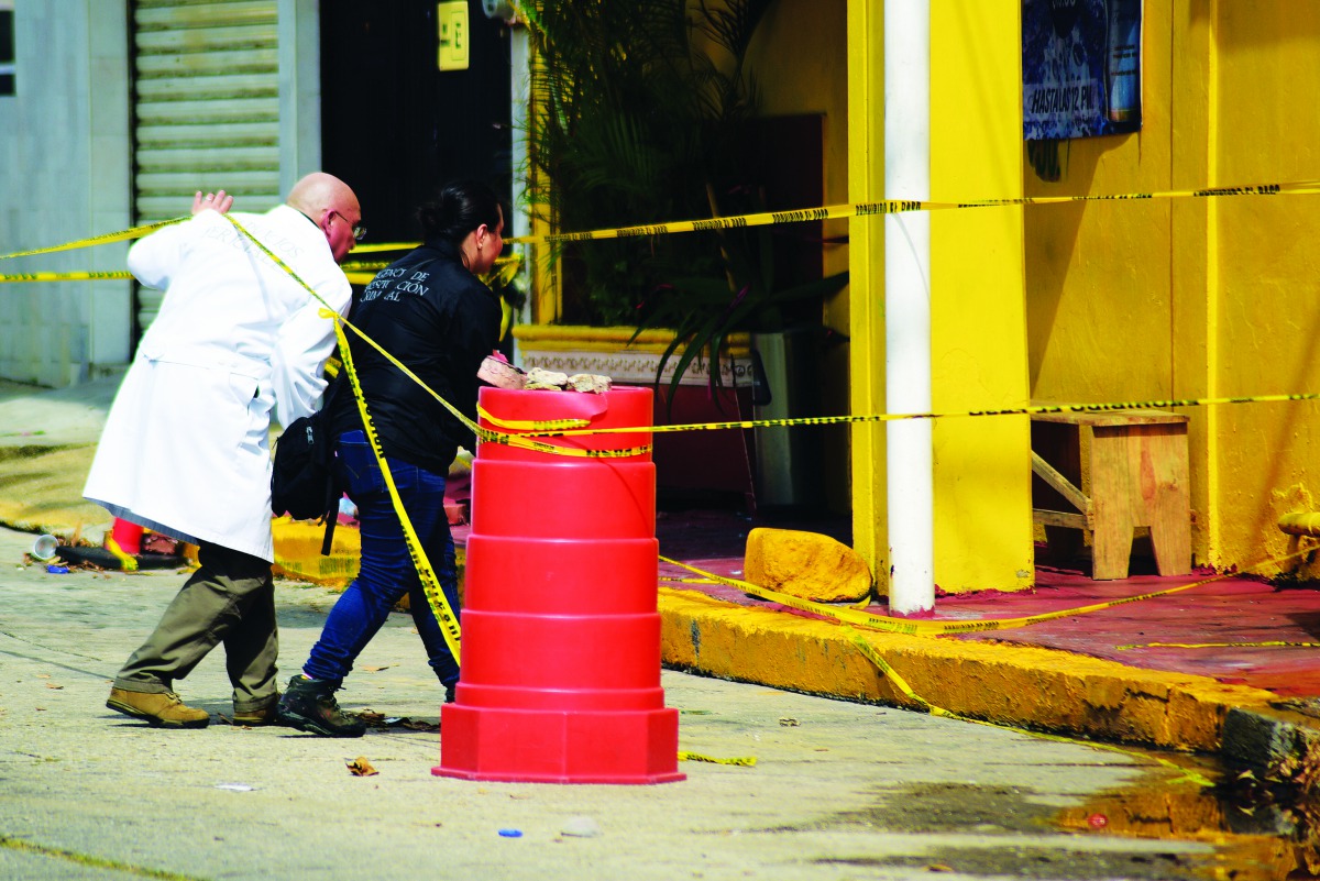 Forensic technicians of the Mexico's Attorney General's office (FGR) enter 