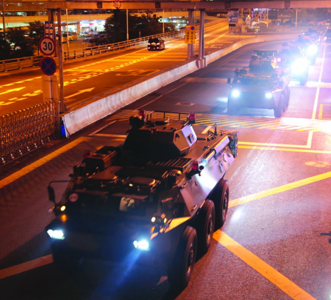 Military vehicles of the Chinese People's Liberation Army (PLA) pass Huanggang Port for a routine troop rotation in Hong Kong, August 29, 2019. Xinhua via Reuters