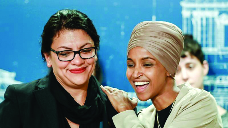 US Representatives Rashida Tlaib and Ilhan Omar react as they discuss travel restrictions to Palestine during a news conference in St Paul, Minnesota.