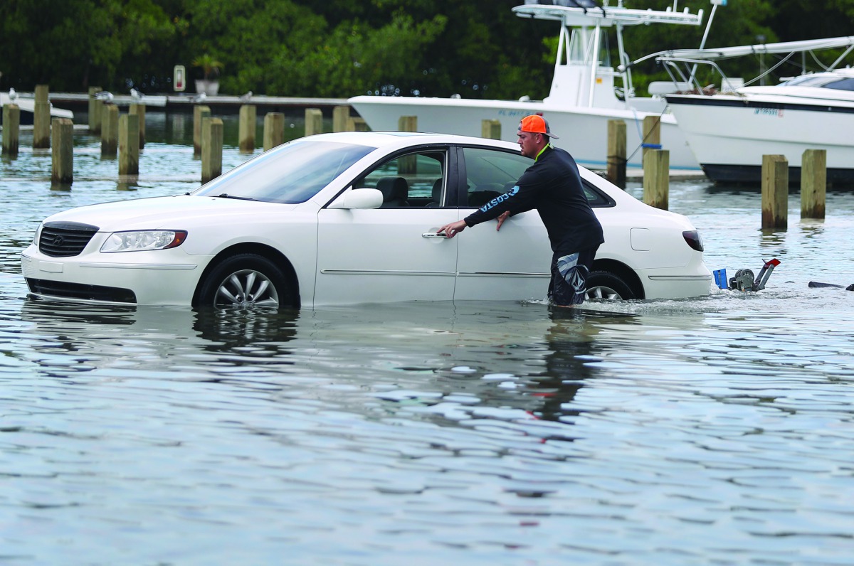 Weston Rice drives through a flooded parking lot as he prepares to drop his jet ski into the water at the Haulover Marine Center before the arrival of Hurricane Dorian on August 30, 2019 in Miami Beach. Joe Raedle/Getty Images/AFP 