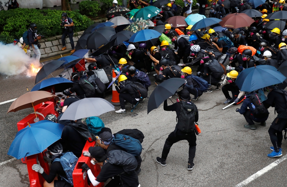 Demonstrators react after police fired tear gas during a protest in Hong Kong, China August 31, 2019. REUTERS/Kai Pfaffenbach