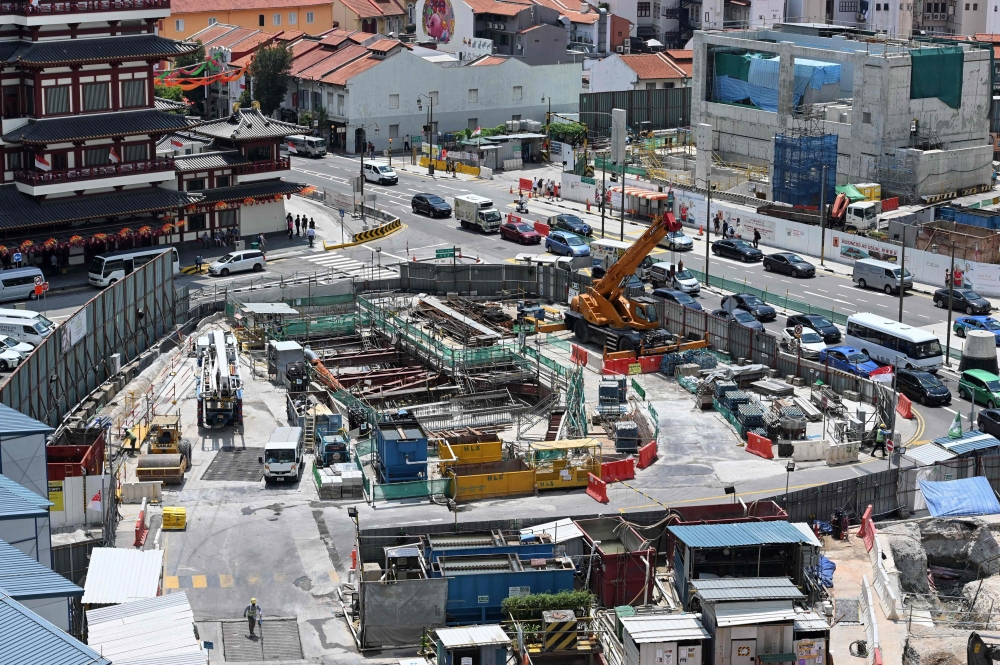 This photograph taken on August 21, 2019, shows a view of the ongoing construction of an underground Mass Rapid Transit (MRT) train station in Singapore. AFP / Roslan Rahman 