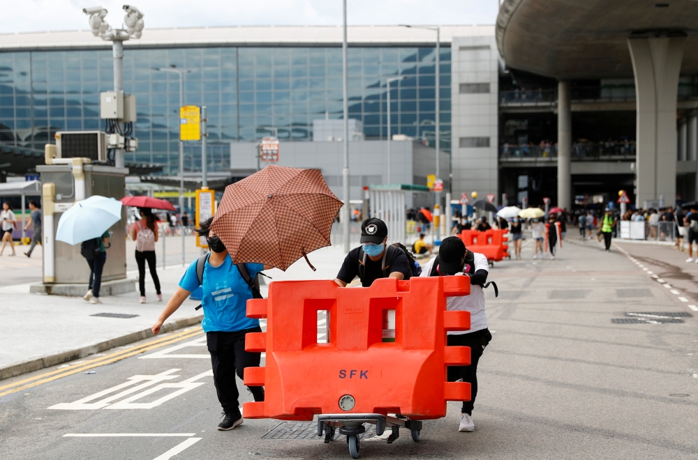 Protesters build barricades outside the terminals at Hong Kong International Airport, in Hong Kong, China September 1, 2019. REUTERS/Kai Pfaffenbach