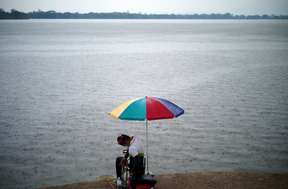 A man fishes on the Phayao lake in Phayao province, Thailand, March 26, 2019. Reuters/Panu Wongcha-um