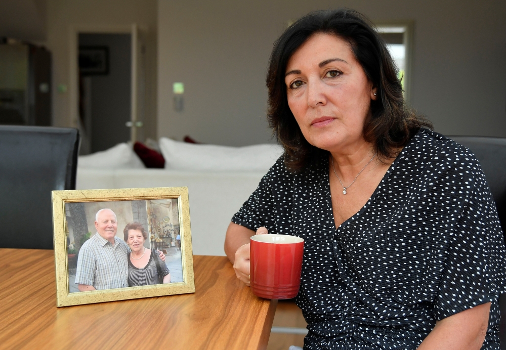 Anna Amato sits for a portrait next to a photograph of her parents Mario and Chiara at her home in Bristol, Britain, August 28, 2019. Picture taken August 28, 2019. Reuters/Toby Melville