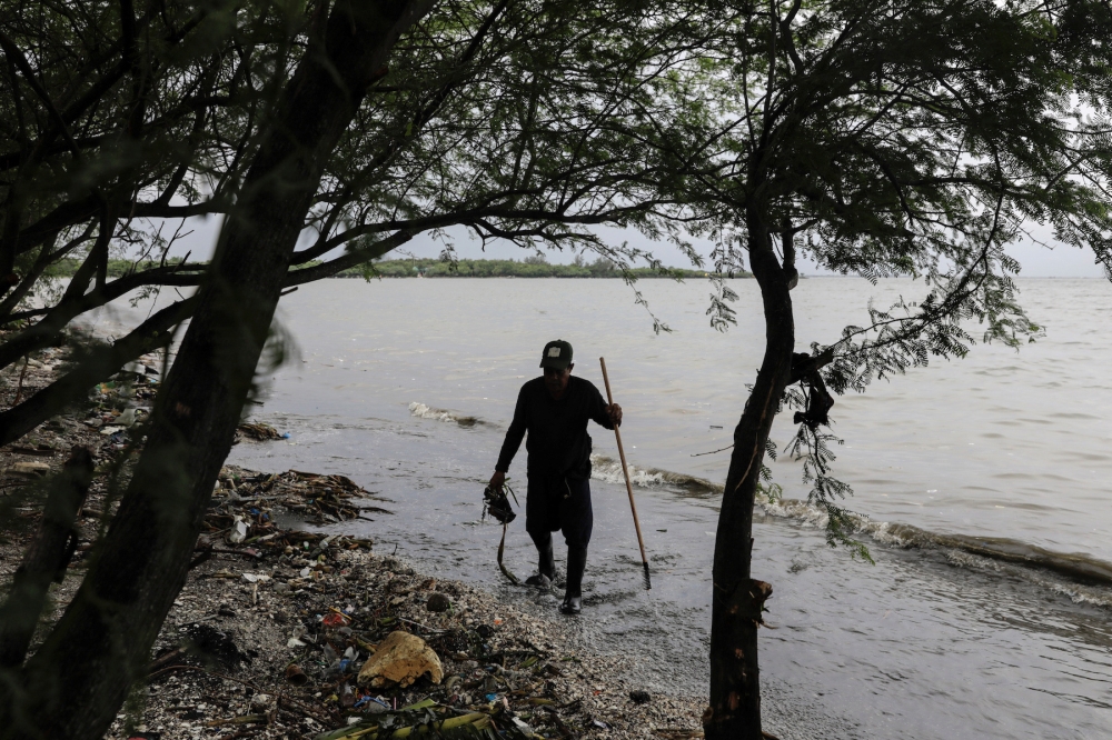 'Bakawan warrior' Willer Gualva picks up trash from a beach on Freedom Island, Paranaque City, Metro Manila, Philippines, July 17, 2019. Picture taken July 17, 2019. REUTERS/Eloisa Lopez