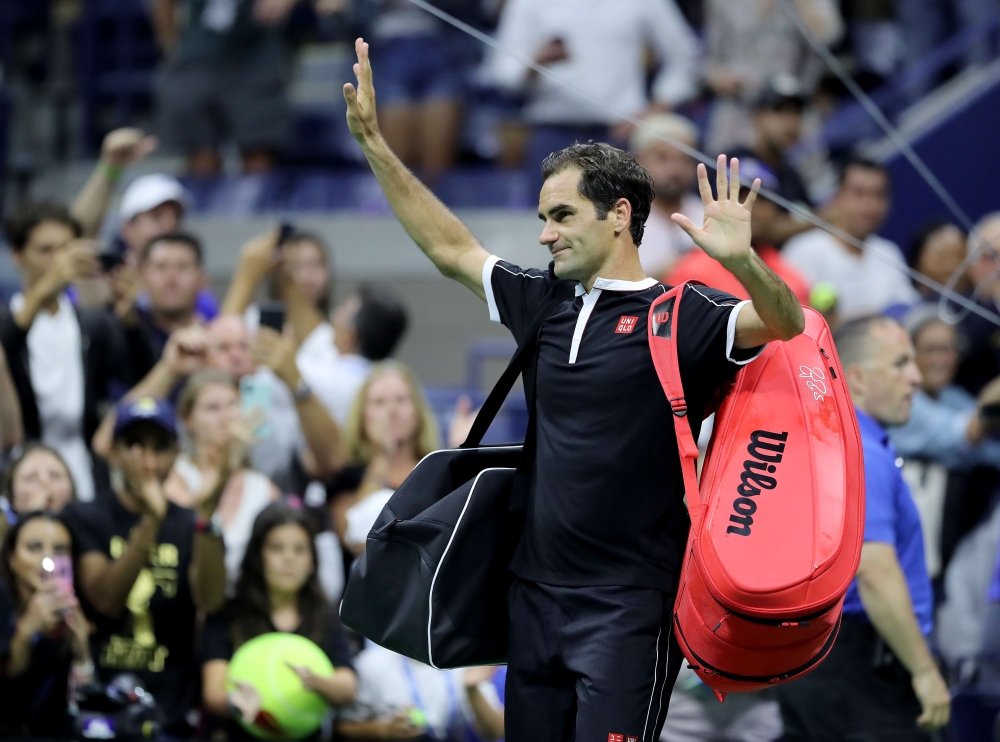 Roger Federer of Switzerland waves to the fans as he walks off the court after his loss to Grigor Dimitrov of Bulgaria during quarterfinal Men's Singles match on day nine of the 2019 US Open at the USTA Billie Jean King National Tennis Center on September