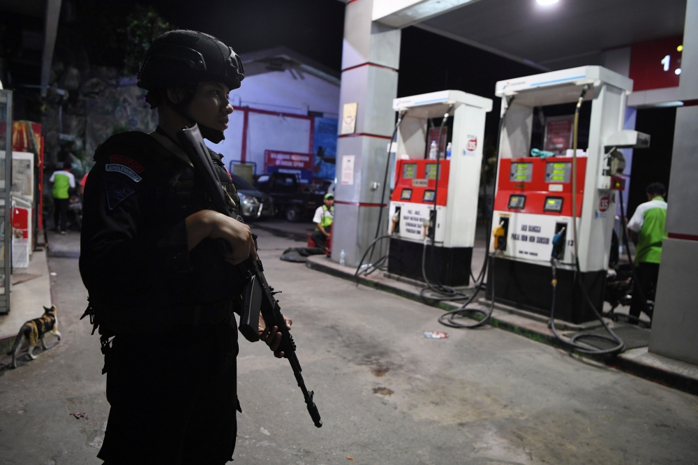 Police Mobile Brigade (Brimob) officer stands guard at a gas station in Jayapura, Papua, August 31, 2019 in this photo taken by Antara Foto. Zabur Karuru/ via Reuters