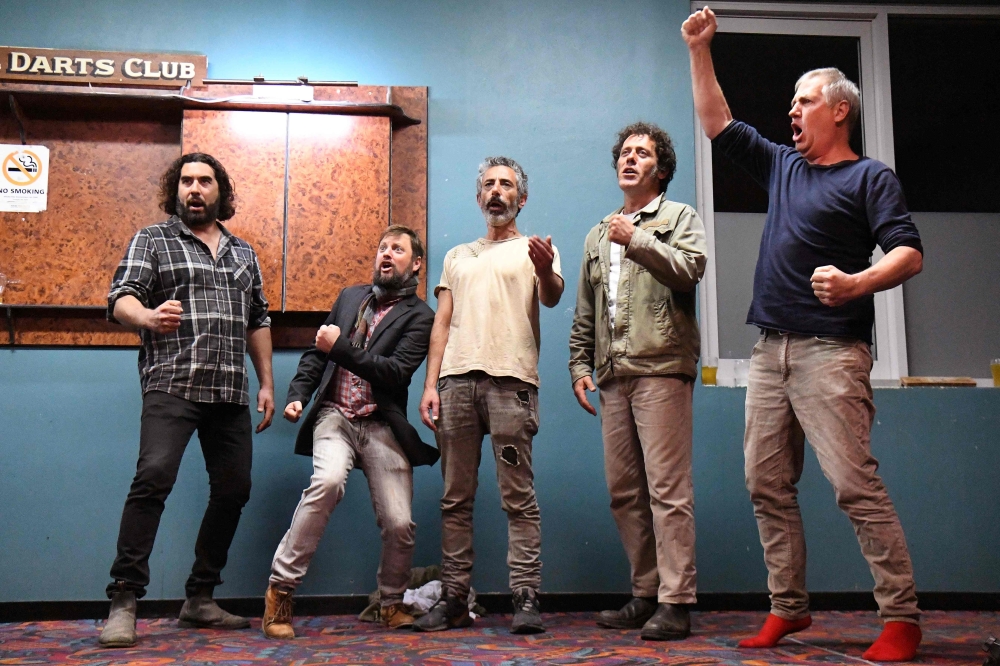 Andrew Swain (R), director of the Dustyesky Choir, leading choir members during a rehearsal in Mullumbimby, on August 27, 2019. AFP / William West