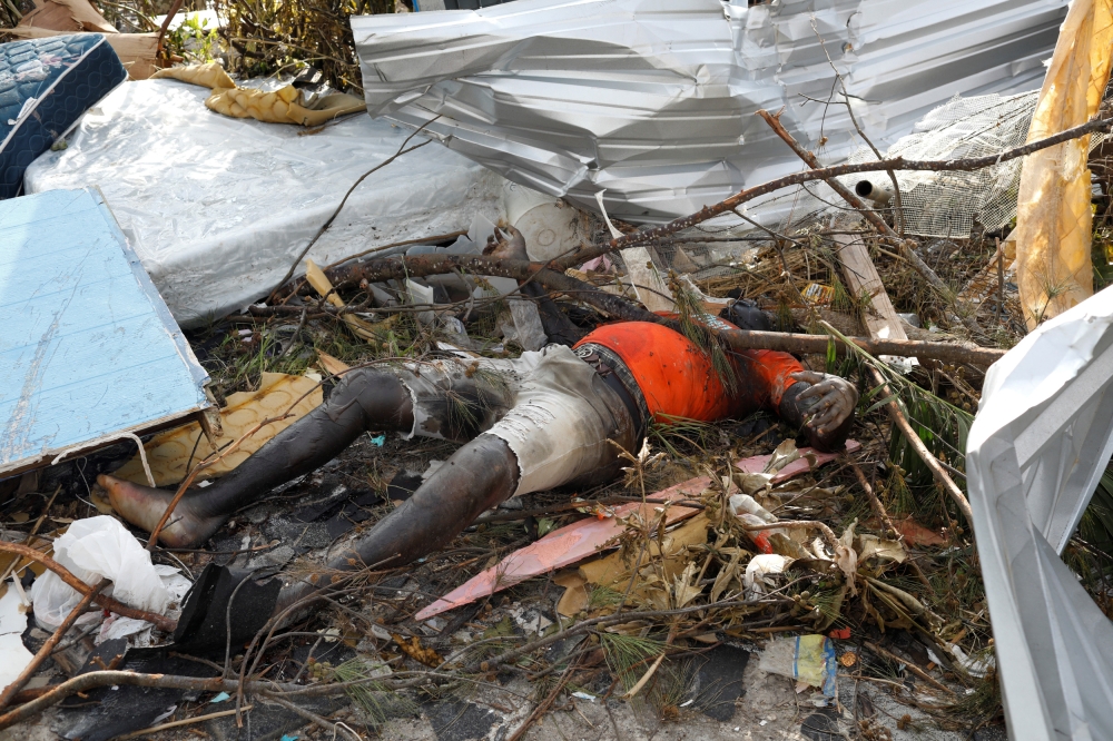  The corpse of a man is seen at the Mudd neighborhood, devastated after Hurricane Dorian hit the Abaco Islands in Marsh Harbour, Bahamas, September 6, 2019. Reuters/Marco Bello