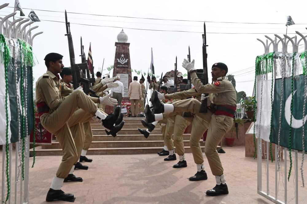Pakistani soldiers pay tribute at a war monument to celebrate Defence Day, which marks the anniversary of the country's second war with India between August and September 1965 with both sides claiming victory after it ended in a stalemate, near Wagah bord