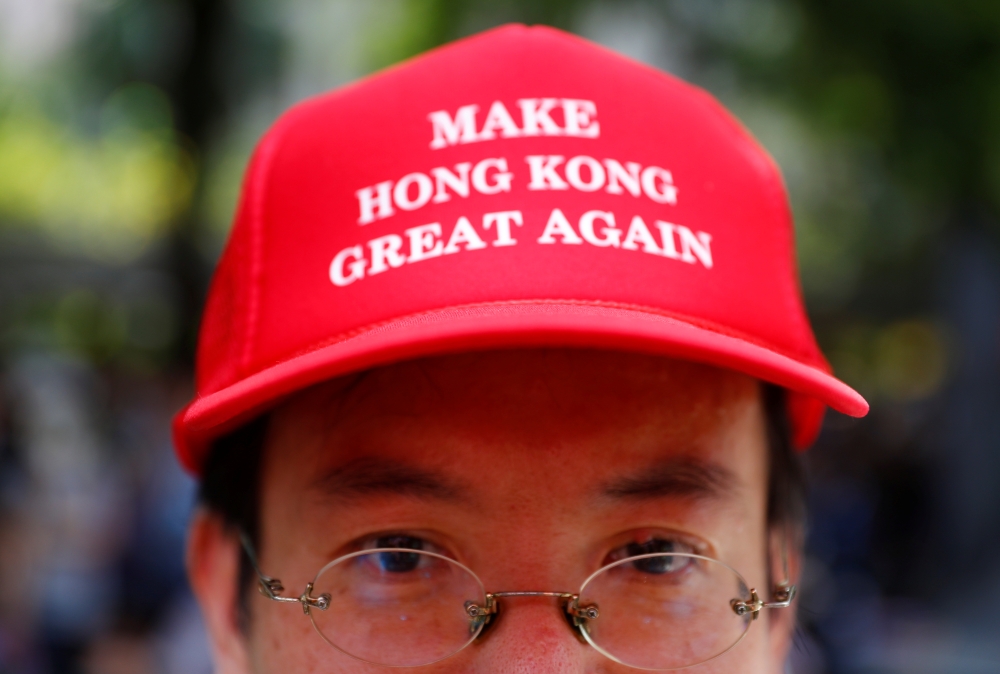 A protester is seen wearing a cap that reads, 