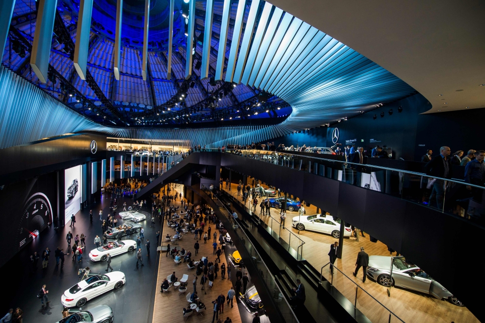 (FILES) In this file photo taken on September 16, 2015 people mill around new cars displayed at the Mercedes Benz hall during the second press day of the 66th IAA auto show in Frankfurt am Main, western Germany. AFP / Odd ANDERSEN