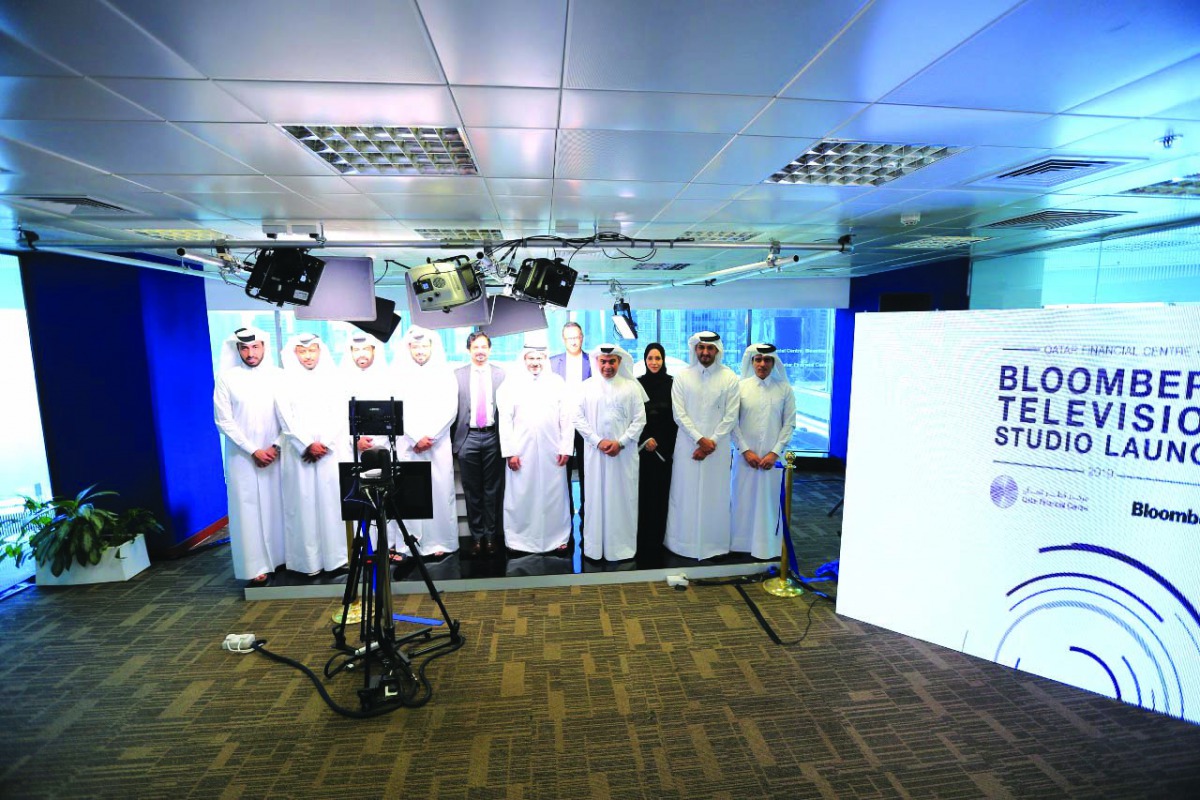 H E Ali bin Ahmed Al Kuwari (third right, front row), Minister of Commerce and Industry, with QFC and Bloomberg officials during the launch event.