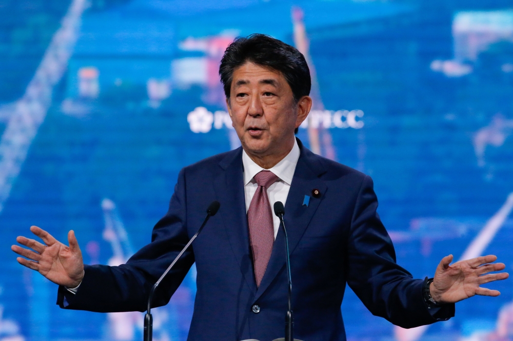 File photo of Japan's Prime Minister Shinzo Abe gives a speech as he takes part in a plenary session of Eastern Economic Forum at far-eastern Russian port of Vladivostok on September 5, 2019. / AFP / TASS Host Photo Agency / Vladimir SMIRNOV 