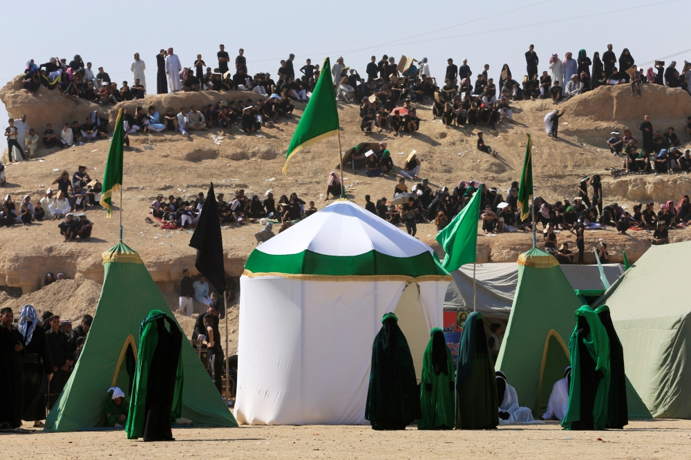 Local actors dressed as ancient warriors re-enact a scene from the 7th century battle of Kerbala during a ceremony marking Ashura in the holy city of Najaf, Iraq, September 10, 2019. Reuters/Alaa Al-Marjani
 
